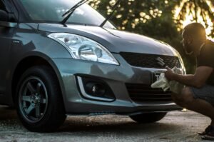 photo of man cleaning his car