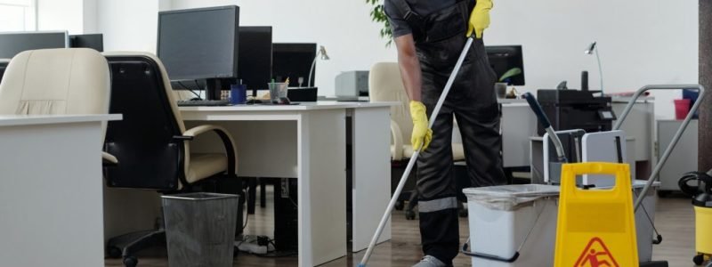 contemporary-young-black-man-in-workwear-cleaning-floor-in-openspace-office-1024x682