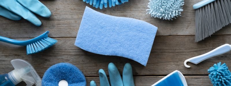 House cleaning product on wood table, blue equipment concept