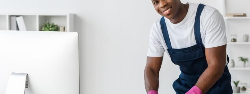 stock-photo-selective-focus-smiling-african-american-cleaner-cleaning-telephone-rag-office